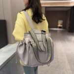Grey 2-in-1 bag worn as a backpack
