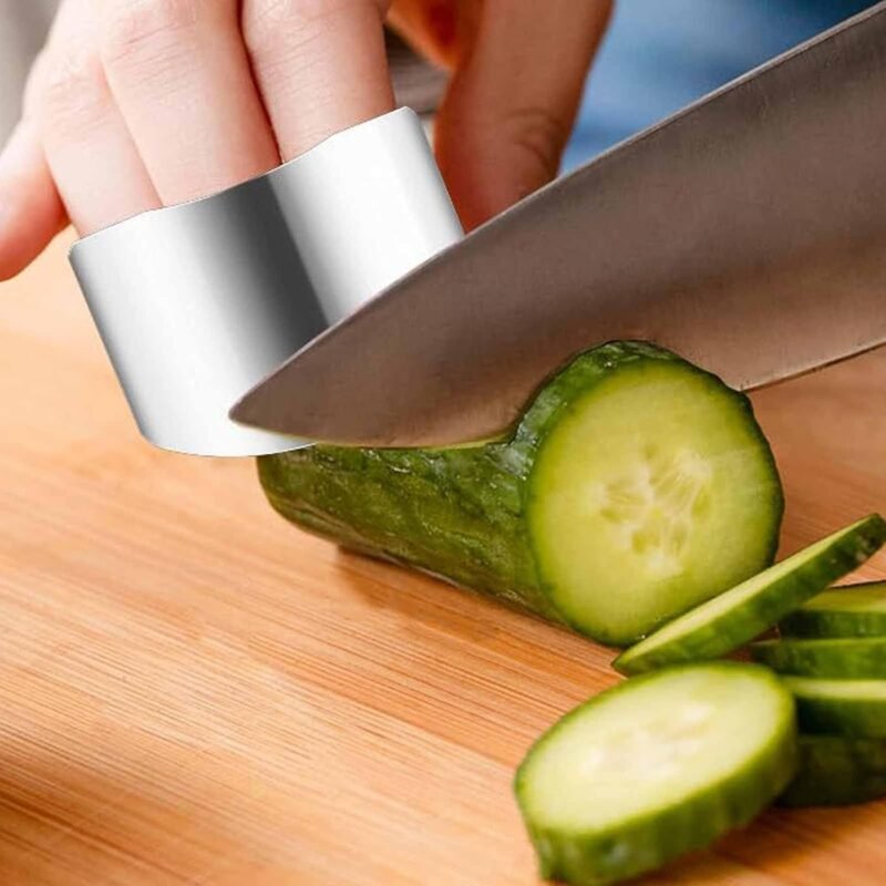 Stainless steel finger guard protecting fingers while slicing cucumber