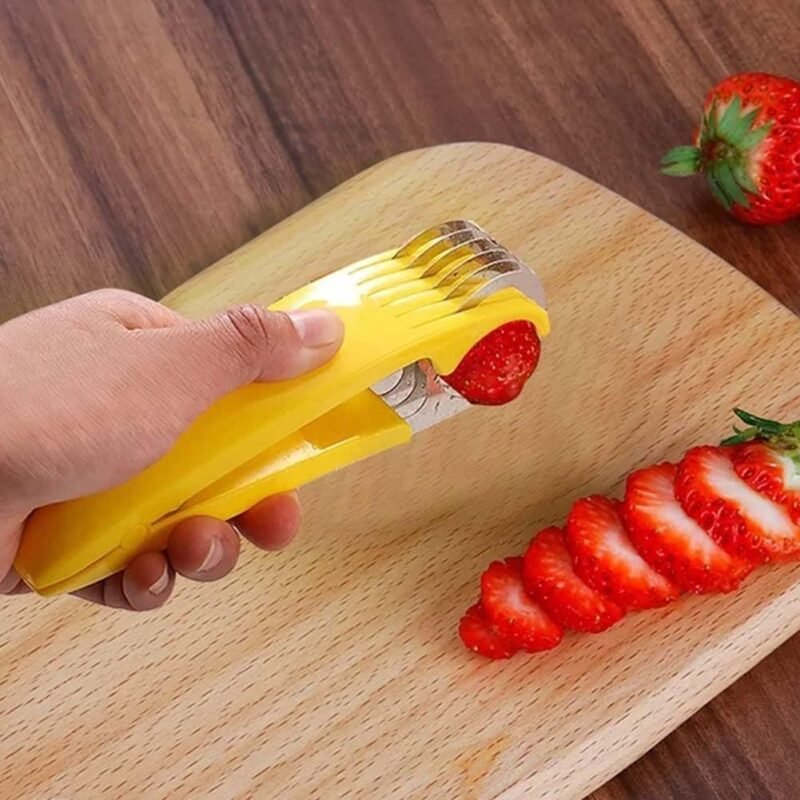Yellow banana slicer cutting strawberries on a wooden board