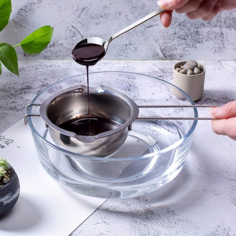 Stainless steel chocolate melting bowl resting over a glass bowl