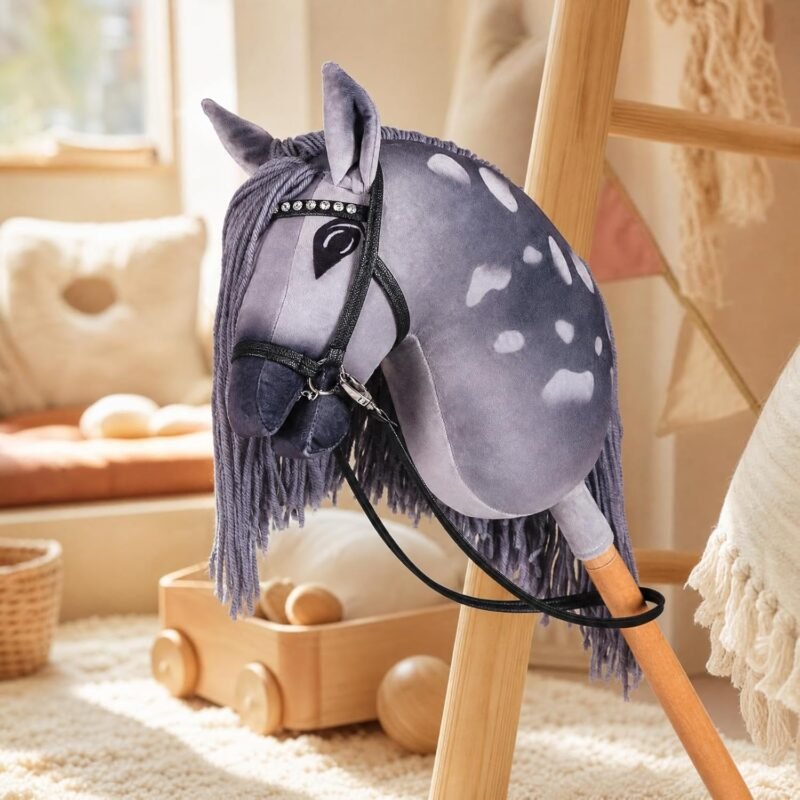 Grey appaloosa stick horse with rhinestone bridle in a bright playroom