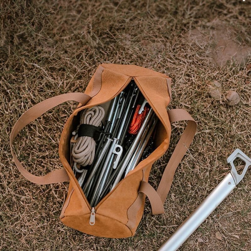 Canvas tent peg storage bag with pegs and rope on the grass