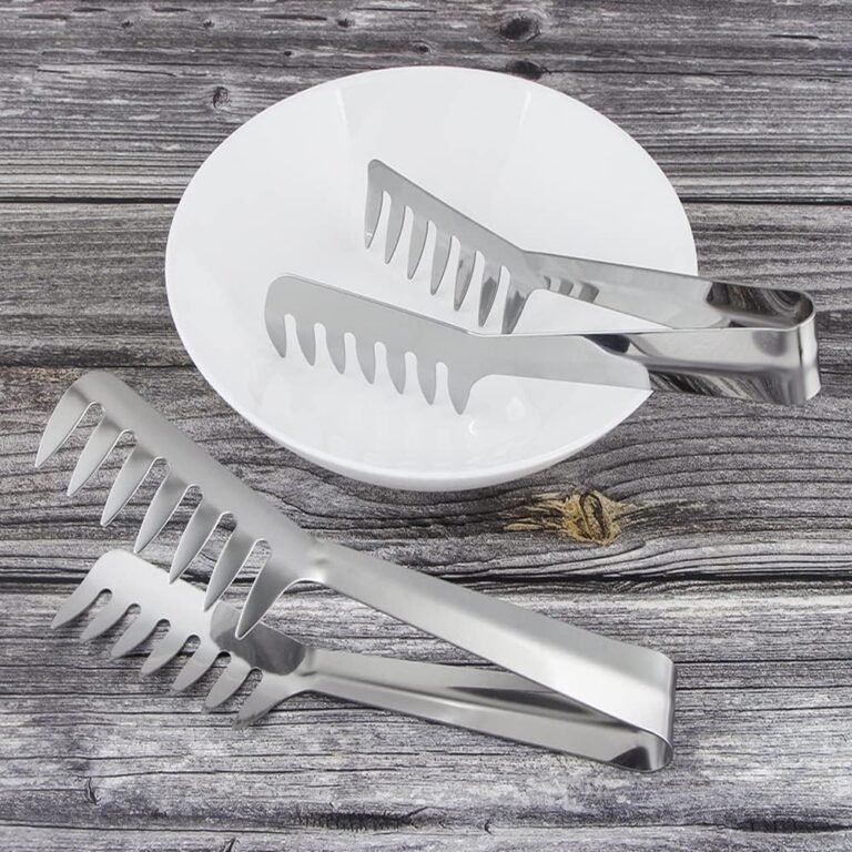 Stainless steel pasta tongs on a rustic wooden table