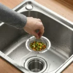 Stainless steel sink strainer basket with handle in a kitchen sink