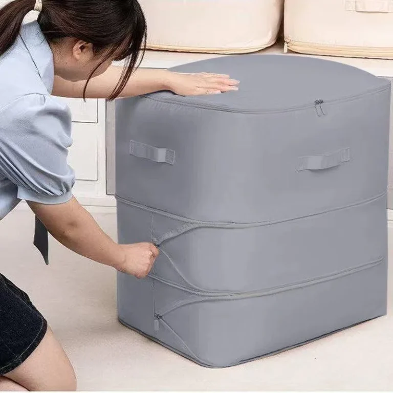 Grey compression storage bag being zipped up in a bedroom