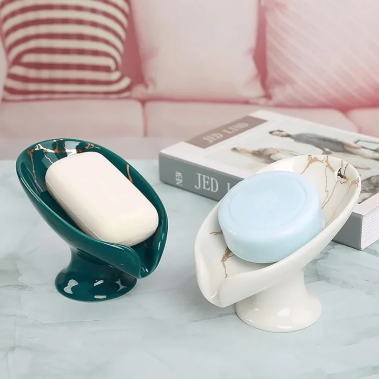 Green and white ceramic self-draining soap dishes on a table