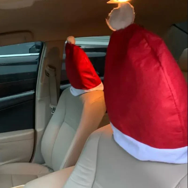 Red Santa hat covers on car seat headrests