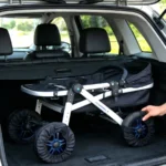 Black pram wheel covers fitted on a pushchair in a car boot