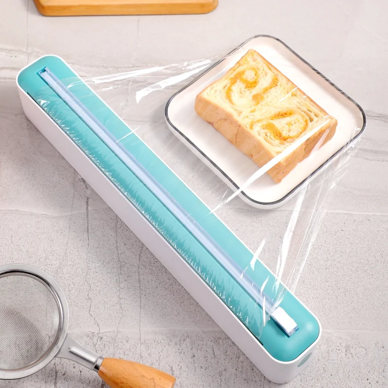 Cling film dispenser in use, wrapping a plate of food