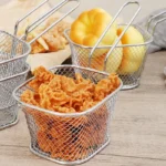 Square mesh chips basket filled with crisps on a wooden table