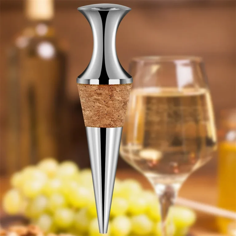 Cork wine stopper beside a glass of white wine and grapes