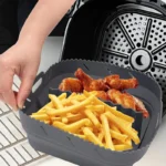 Square silicone air fryer liner with divider, holding chips and chicken wings