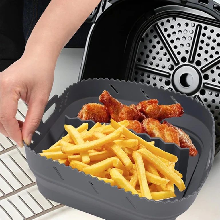 Square silicone air fryer liner with divider, holding chips and chicken wings