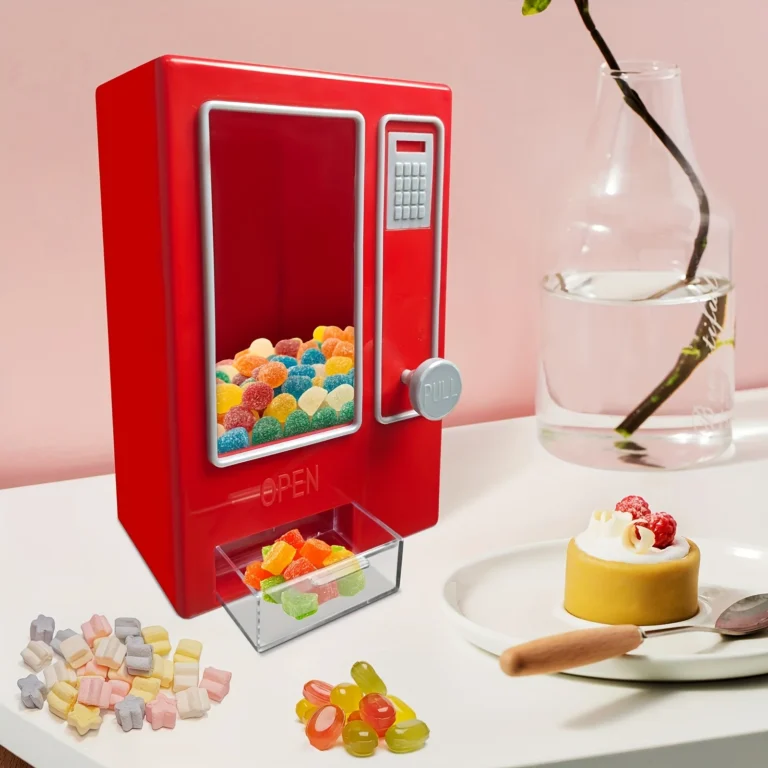 Red mini sweet dispenser filled with gummies on a table
