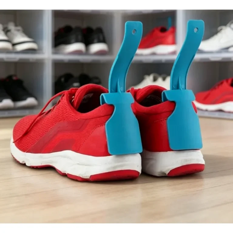 Blue shoe aids in red trainers on a wooden floor in front of a shoe rack