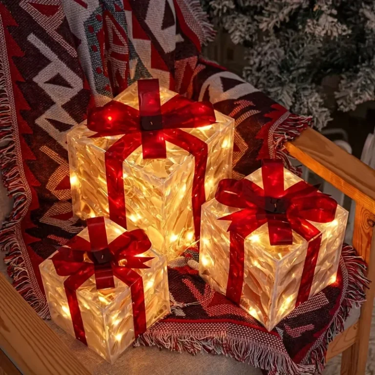 Three light-up gift boxes with red bows glowing on a chair with a blanket
