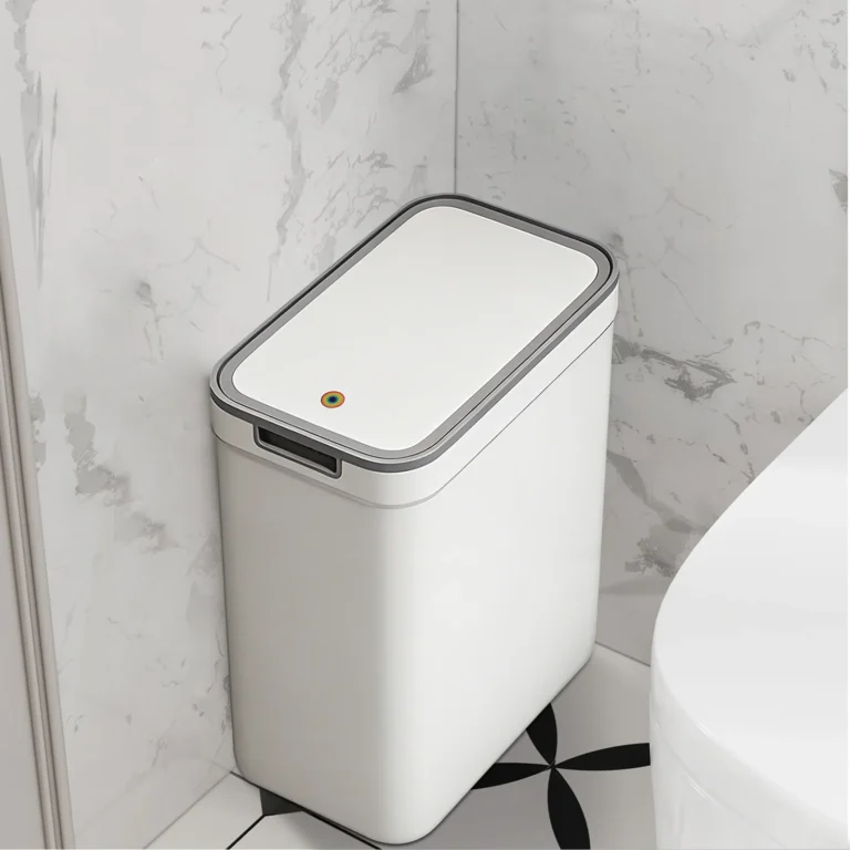 White bathroom bin with grey-rimmed lid in a bathroom corner