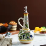 Hand-painted ceramic olive oil bottle on a dining table