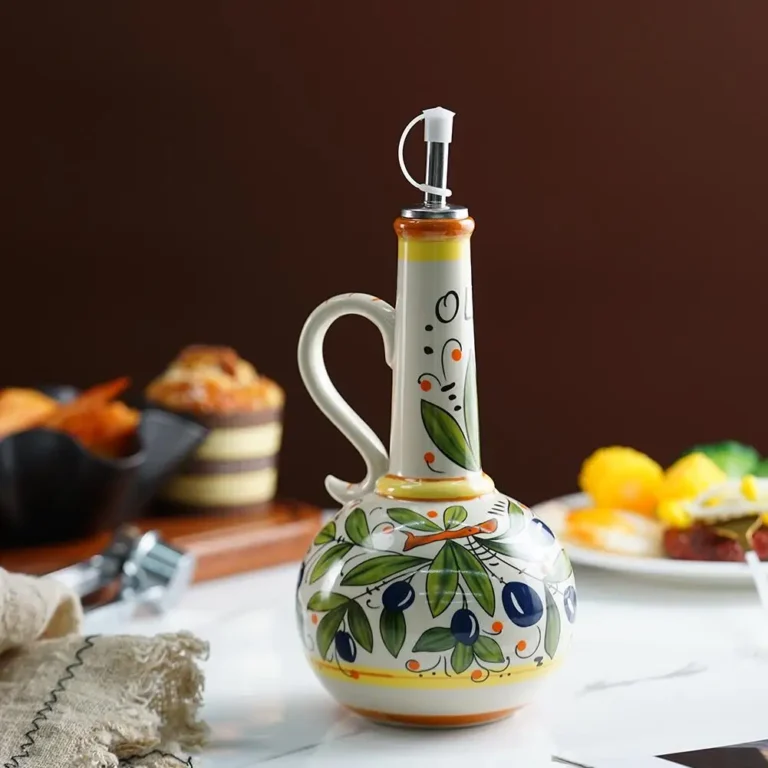 Hand-painted ceramic olive oil bottle on a dining table