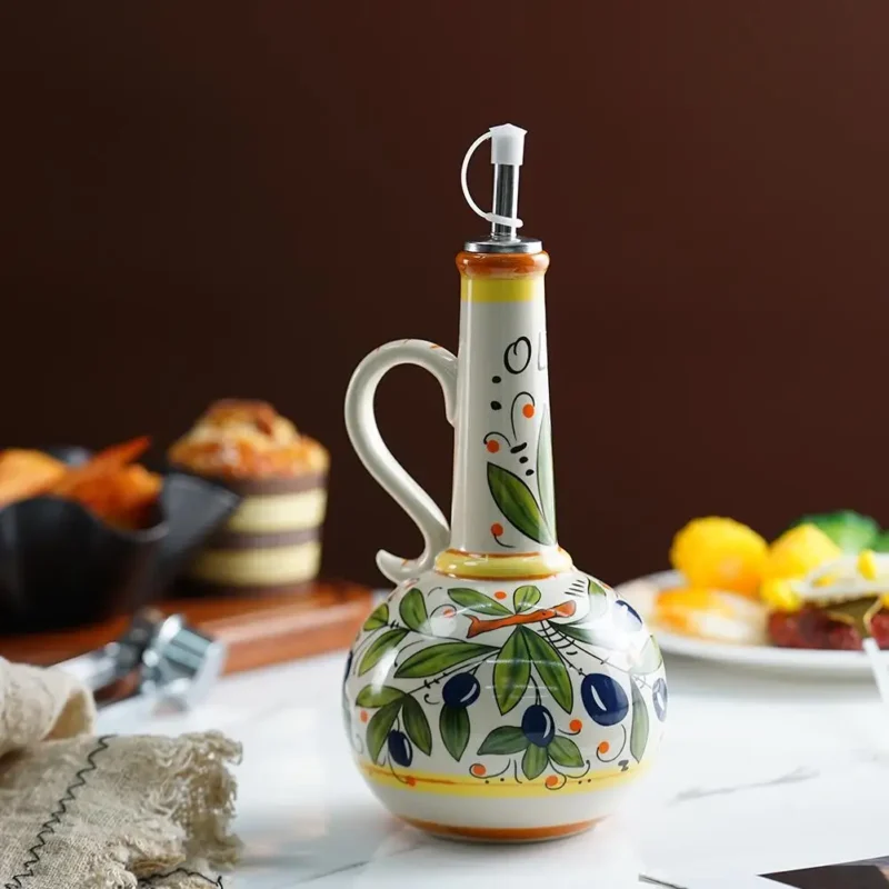 Hand-painted ceramic olive oil bottle on a dining table