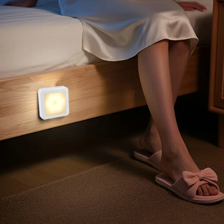 Square LED motion sensor night light on a bed frame