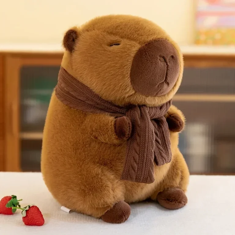 Capybara plush with knitted scarf on a table in a living room with strawberries