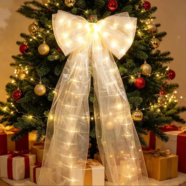 Large light-up bow on a decorated Christmas tree with presents underneath