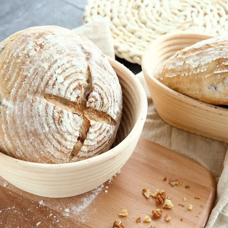 Round rattan proofing basket with a fresh sourdough loaf