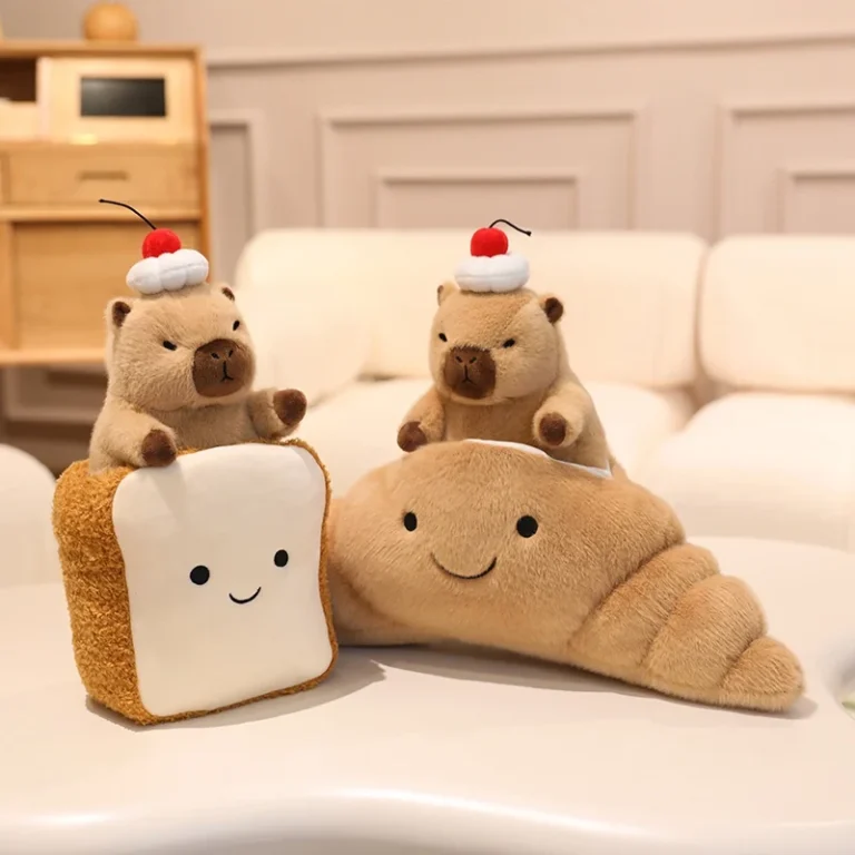 Capybara plush toys in toast and croissant on a cream sofa in a living room