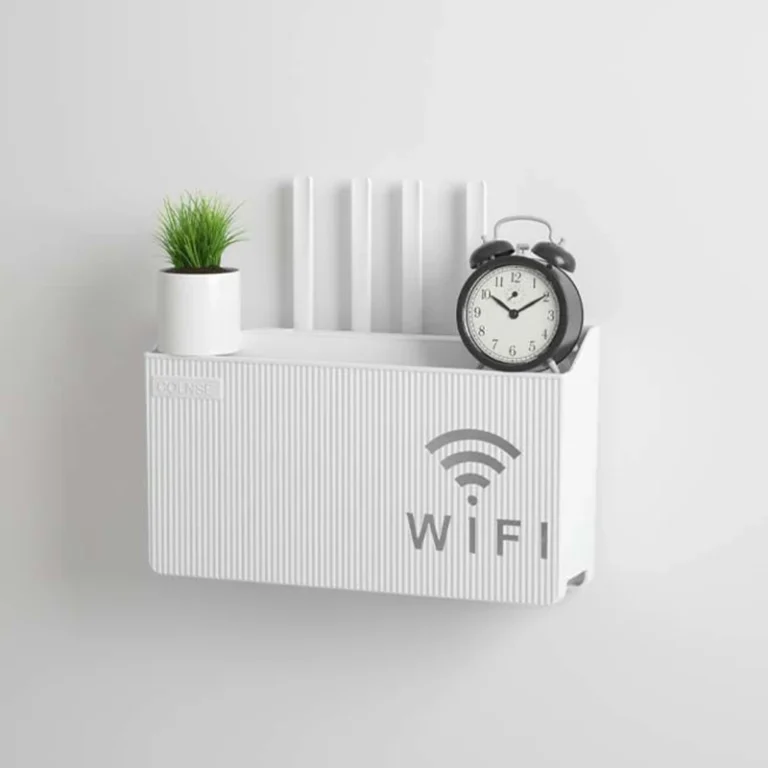White wall-mounted router storage box with WiFi print, holding a plant and alarm clock