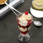 Long stainless steel spoon in an ice cream sundae glass