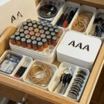 Battery storage boxes with AA and AAA batteries in a drawer