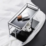 Black countertop organiser with perfume and cup
