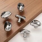 Silver organic furniture knobs on wood