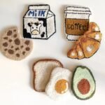 Finished punch needle coasters with food designs